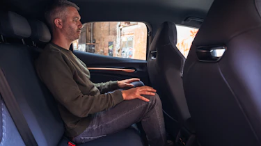 Auto Express deputy editor Richard Ingram sitting in the Cupra Raval's rear seat