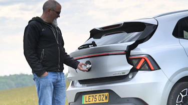 Auto Express senior test editor Dean Gibson opening the MG4 Urban's tailgate