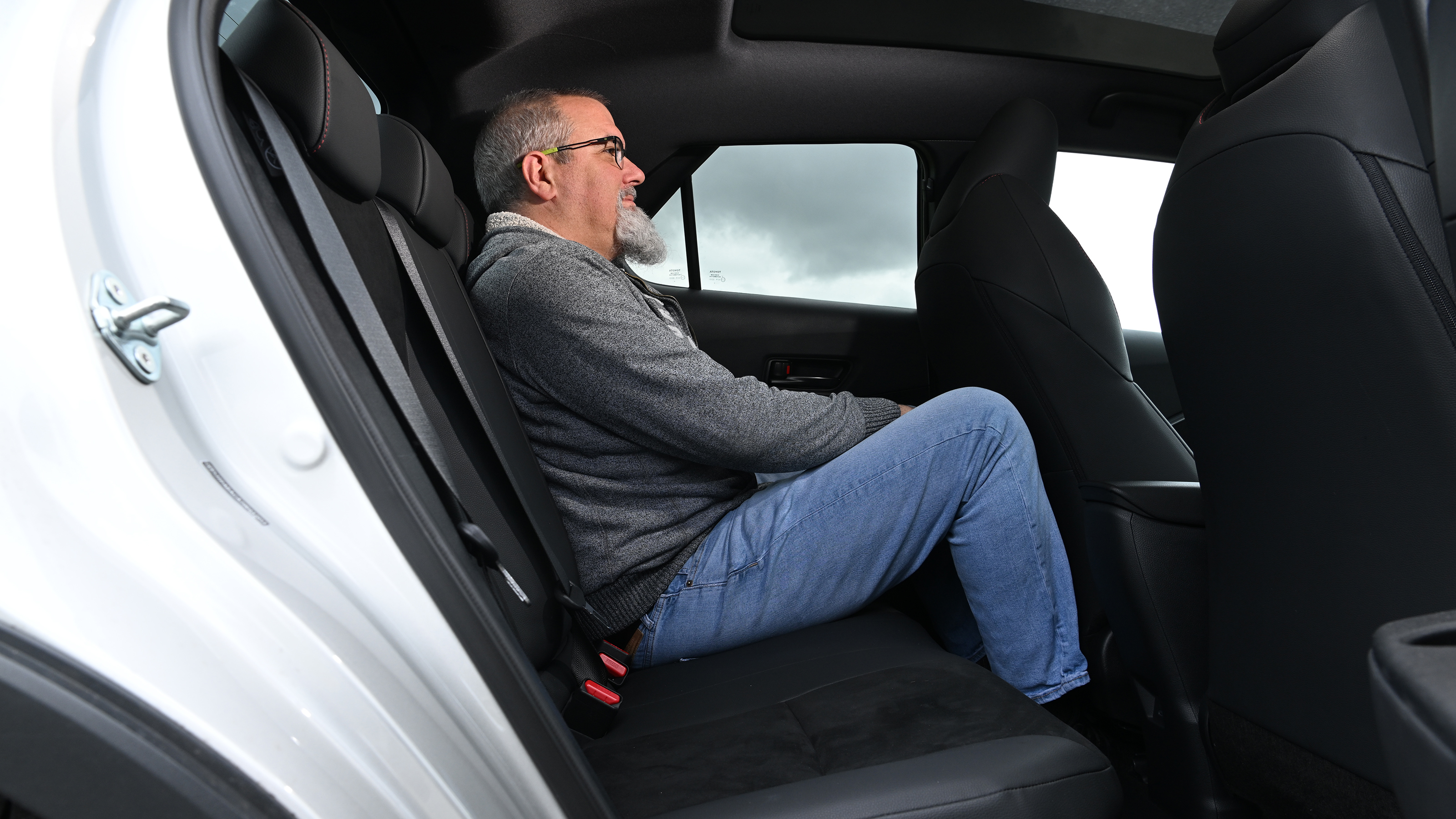 Auto Express senior test editor Dean Gibson sitting in the Toyota C-HR's rear seat