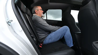 Auto Express senior test editor Dean Gibson sitting in the Toyota C-HR's rear seat