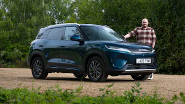Auto Express news reporter Ellis Hyde standing next to the BYD Atto 2 DM-i