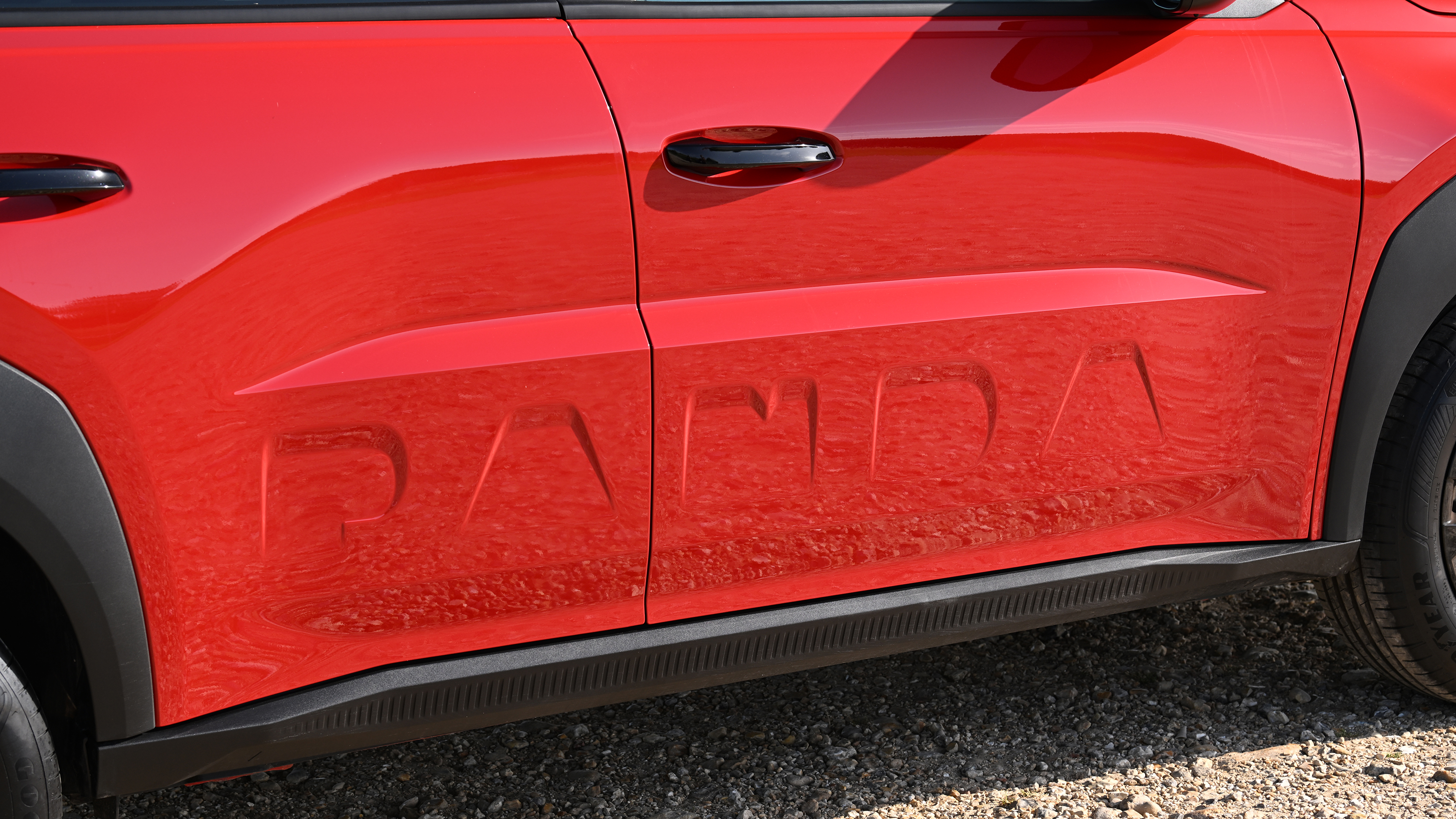 Fiat Grande Panda hybrid - side Panda logo