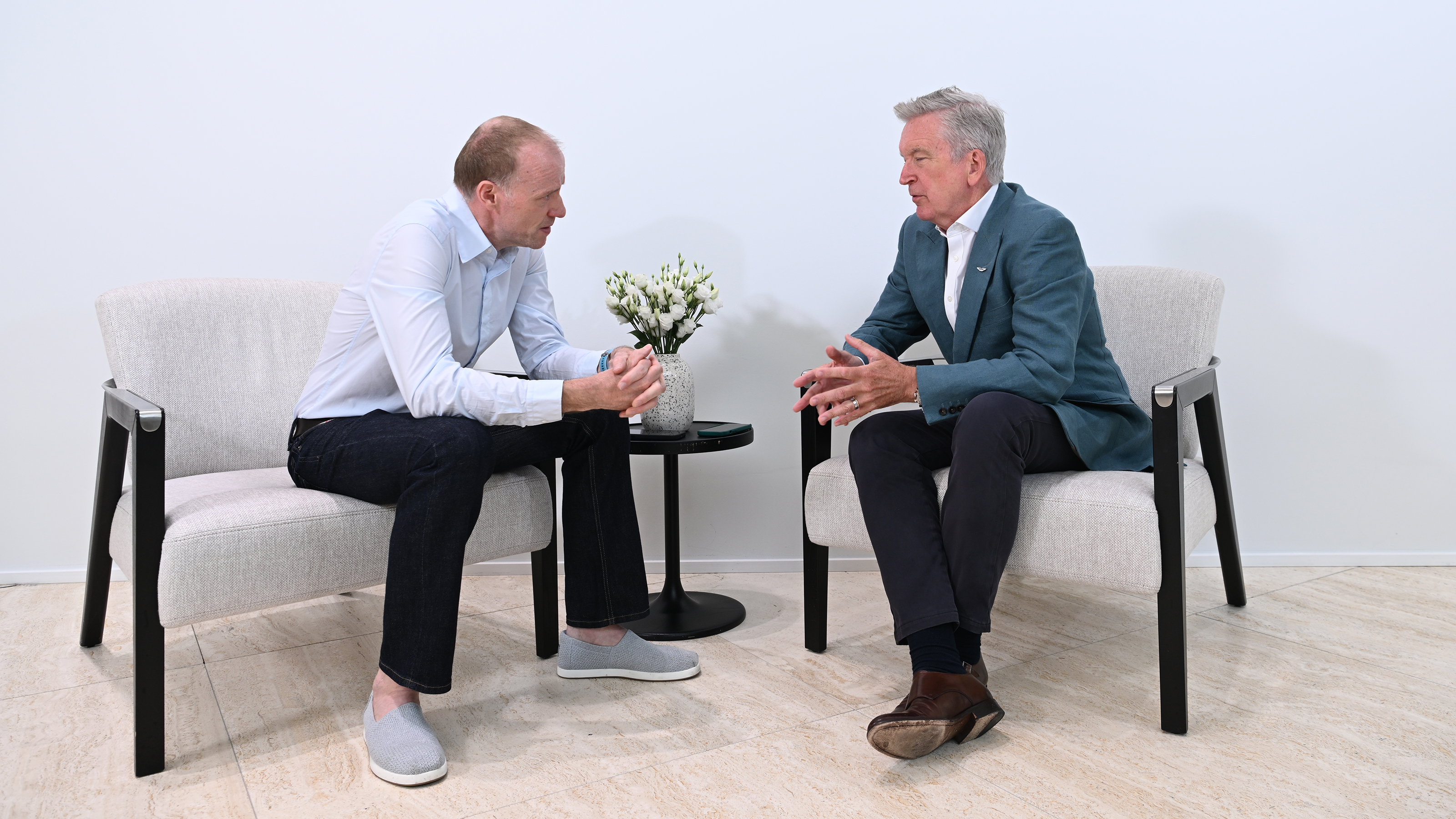 Aston CEO Adrian Hallmark talking to Phil McNamara white room