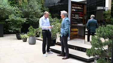 Aston CEO Adrian Hallmark talking to Phil McNamara outside