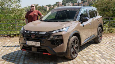 Auto Express news repoter Ellis Hyde standing next to the Nissan X-Trail