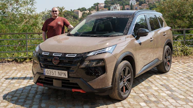 Auto Express news repoter Ellis Hyde standing next to the Nissan X-Trail