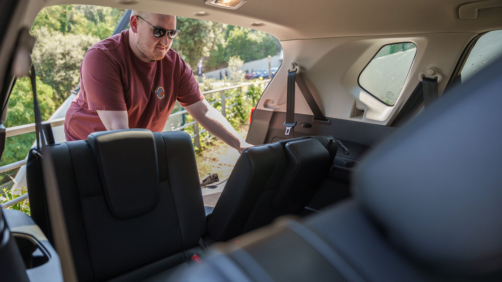 Auto Express news reporter Ellis Hyde folding the Nissan X-Trail's rearmost seats