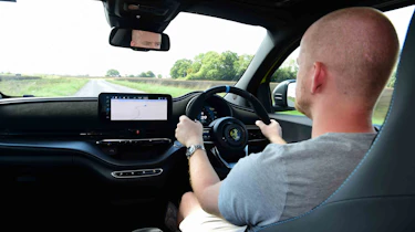 Abarth 500e - interior driving shot wi special contributor Alex Ingram