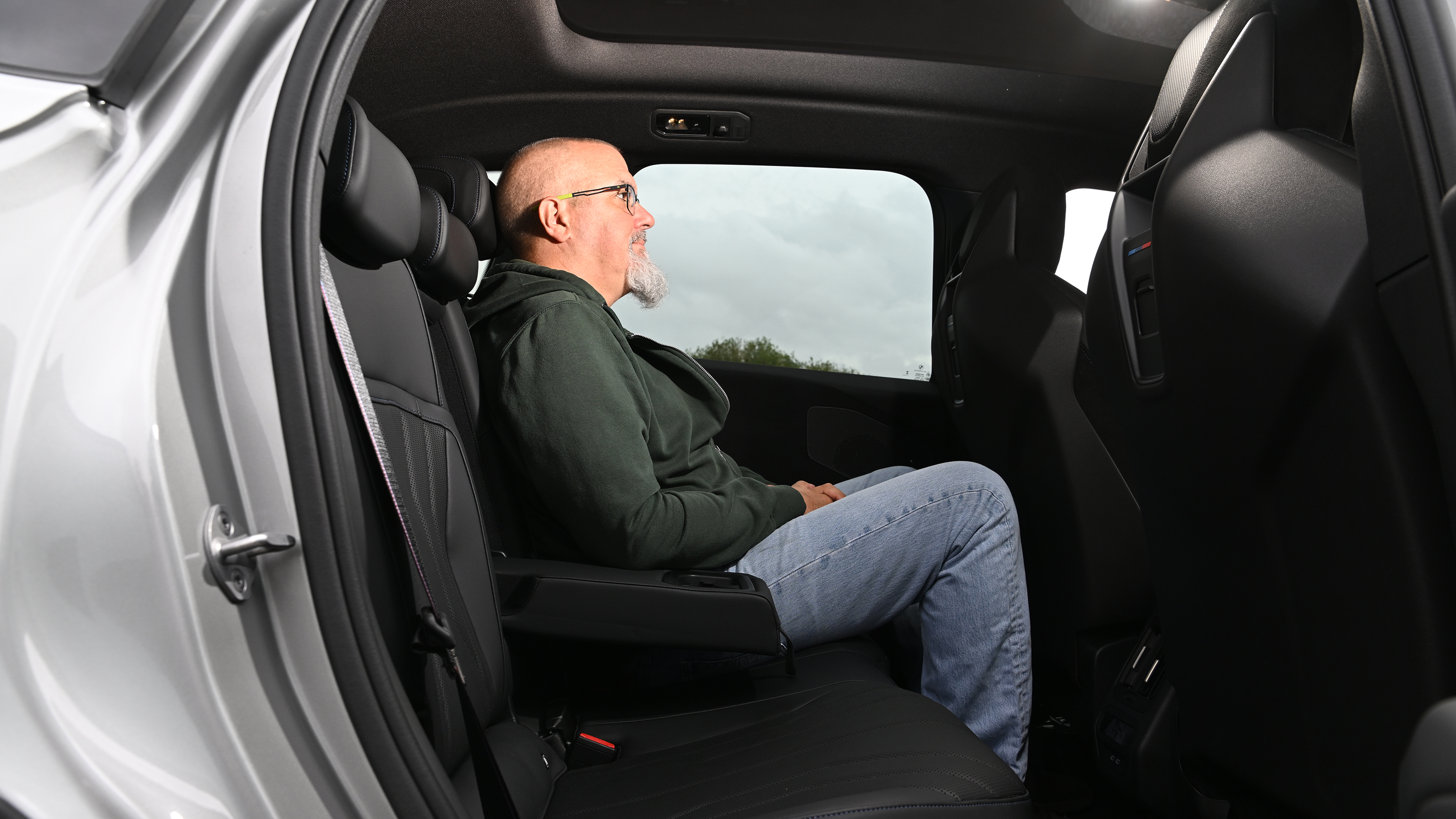BMW iX3 2026 - rear seats, being sat in by Auto Express senior test editor Dean Gibson