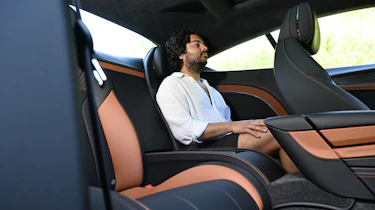 Auto Express news editor Jordan Katsianis sitting in the Bentley Continental GT's rear seat