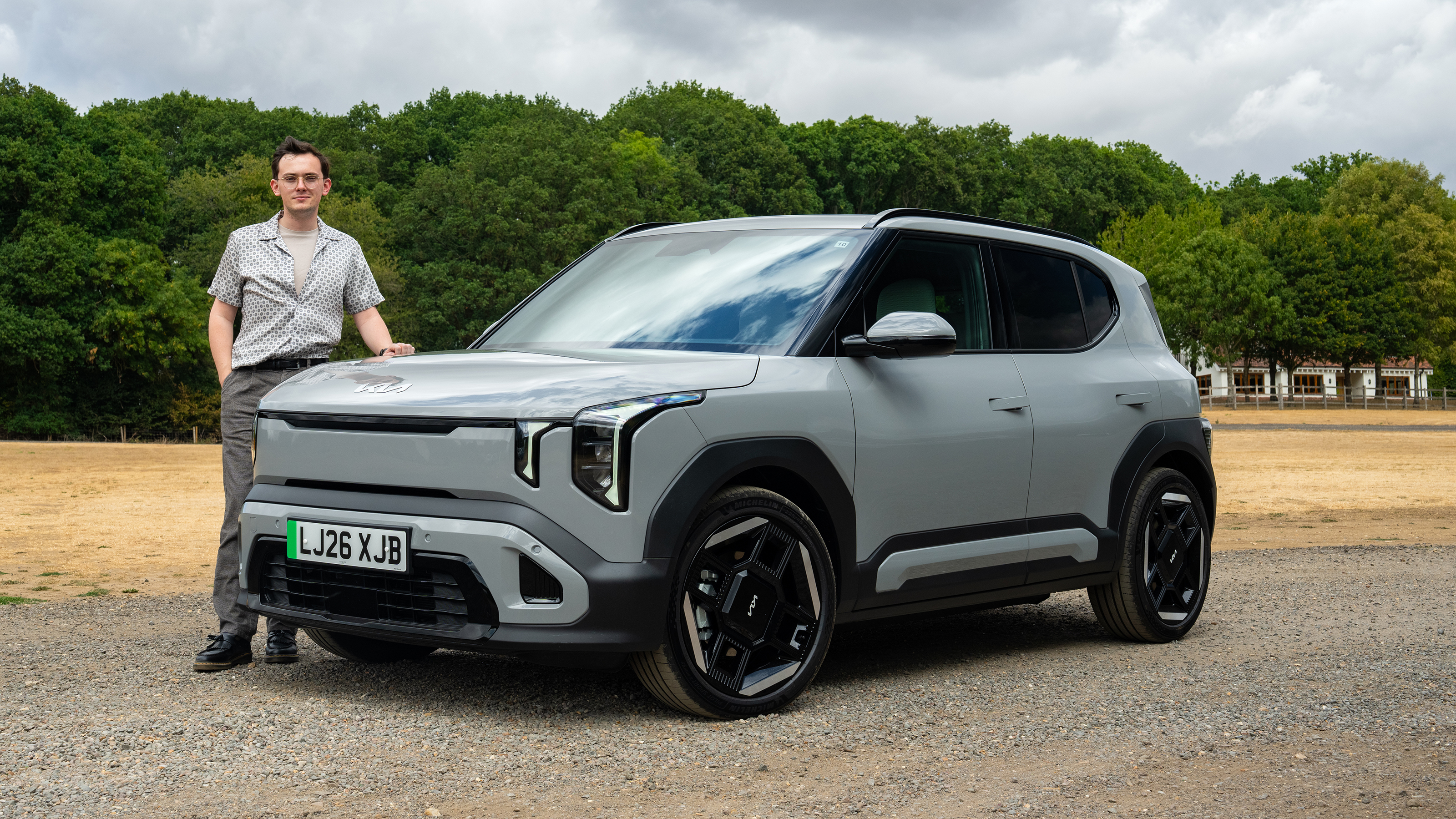 Kia EV2 Long Range - front static with Auto Express consumer reporter Tom Jervis stood next to the car