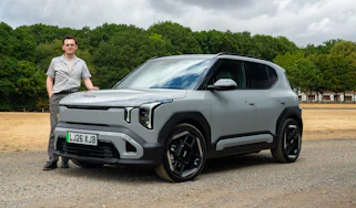 Kia EV2 Long Range - front static with Auto Express consumer reporter Tom Jervis stood next to the car