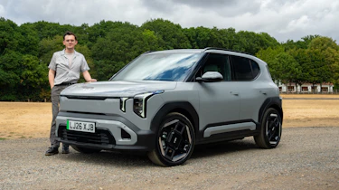 Kia EV2 Long Range - front static with Auto Express consumer reporter Tom Jervis stood next to the car