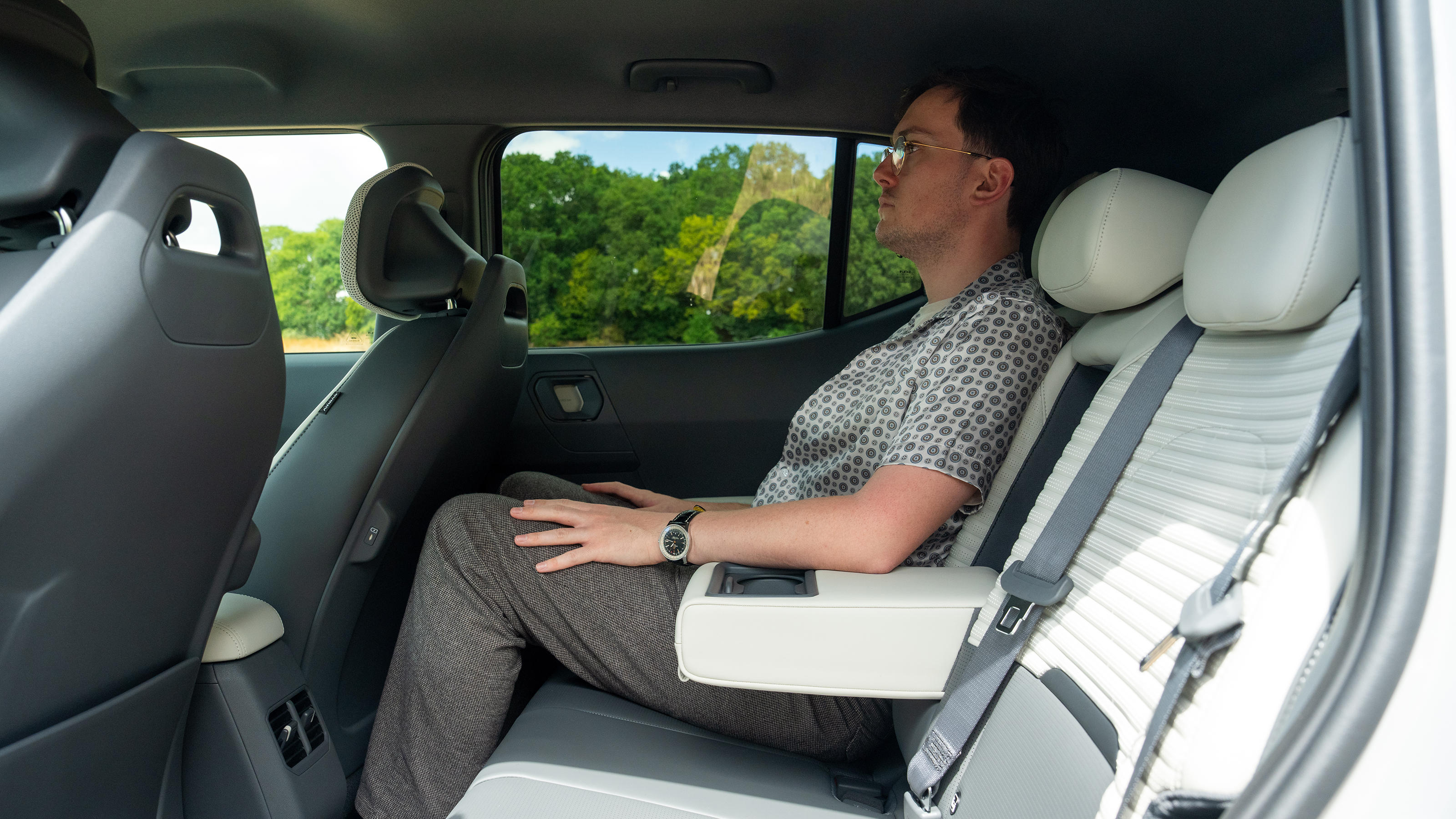 Kia EV2 Long Range - rear interior, back seats being sat in by Auto Express consumer reporter Tom Jervis 