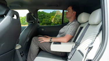 Kia EV2 Long Range - rear interior, back seats being sat in by Auto Express consumer reporter Tom Jervis
