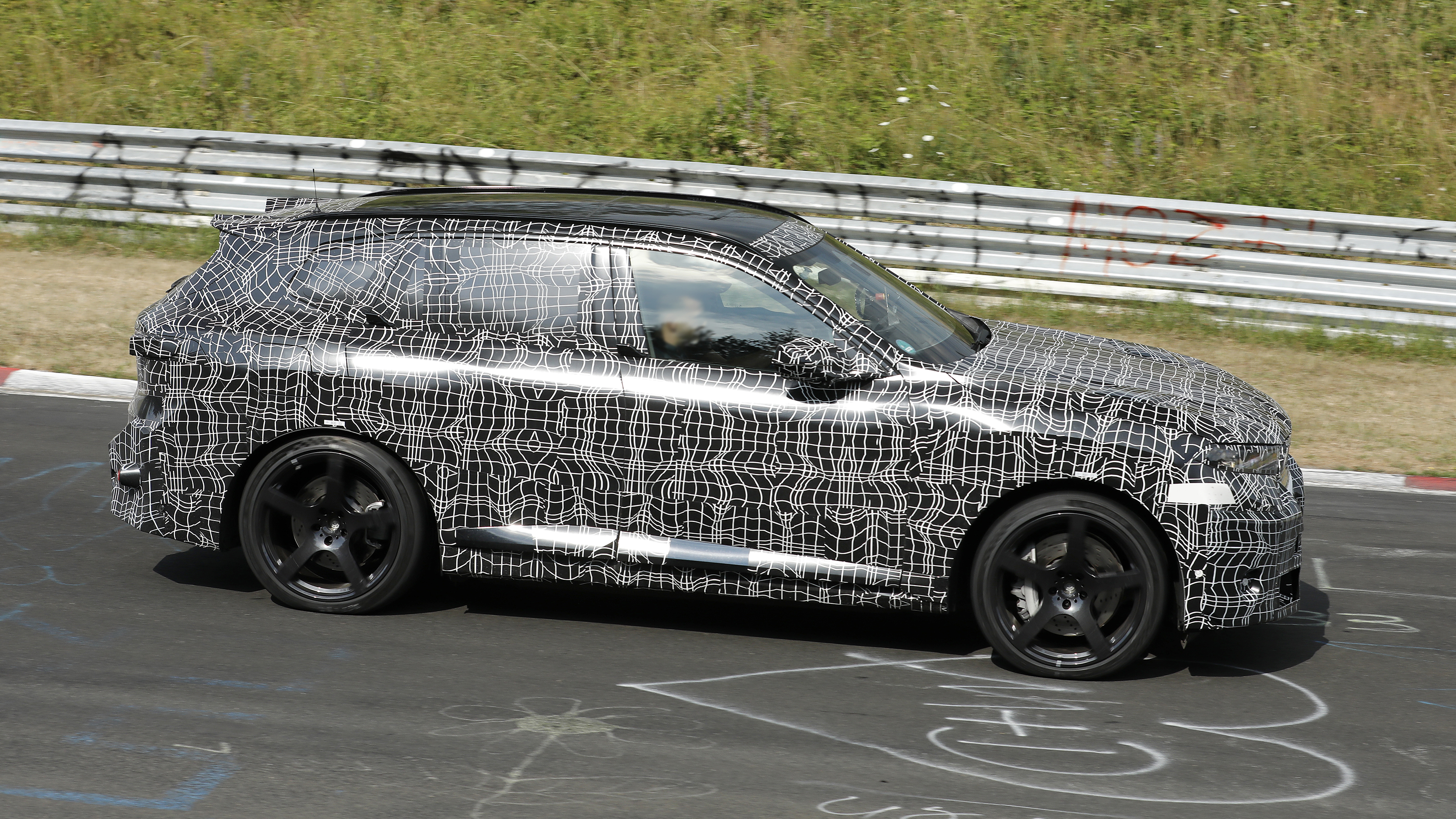New BMW iX5 M at the Nurburgring - side action