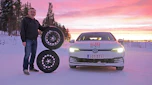 John Barker standing next to two wheels and a VW Golf