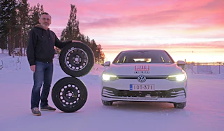 John Barker standing next to two wheels and a VW Golf