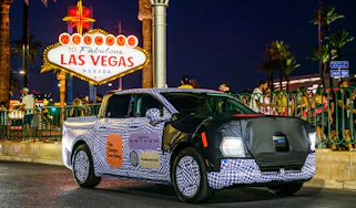 Ford Fathom prototype driving past the Las Vegas sign