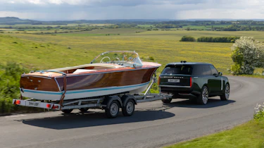 Range Rover Electric towing a boat