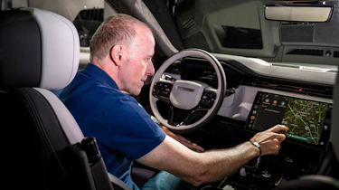 Phil McNamara sat in the Range Rover Sport Electric