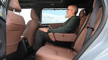 Auto Express senior road test editor Dean Gibson sitting in the Mitsubishi Outlander's rear seat