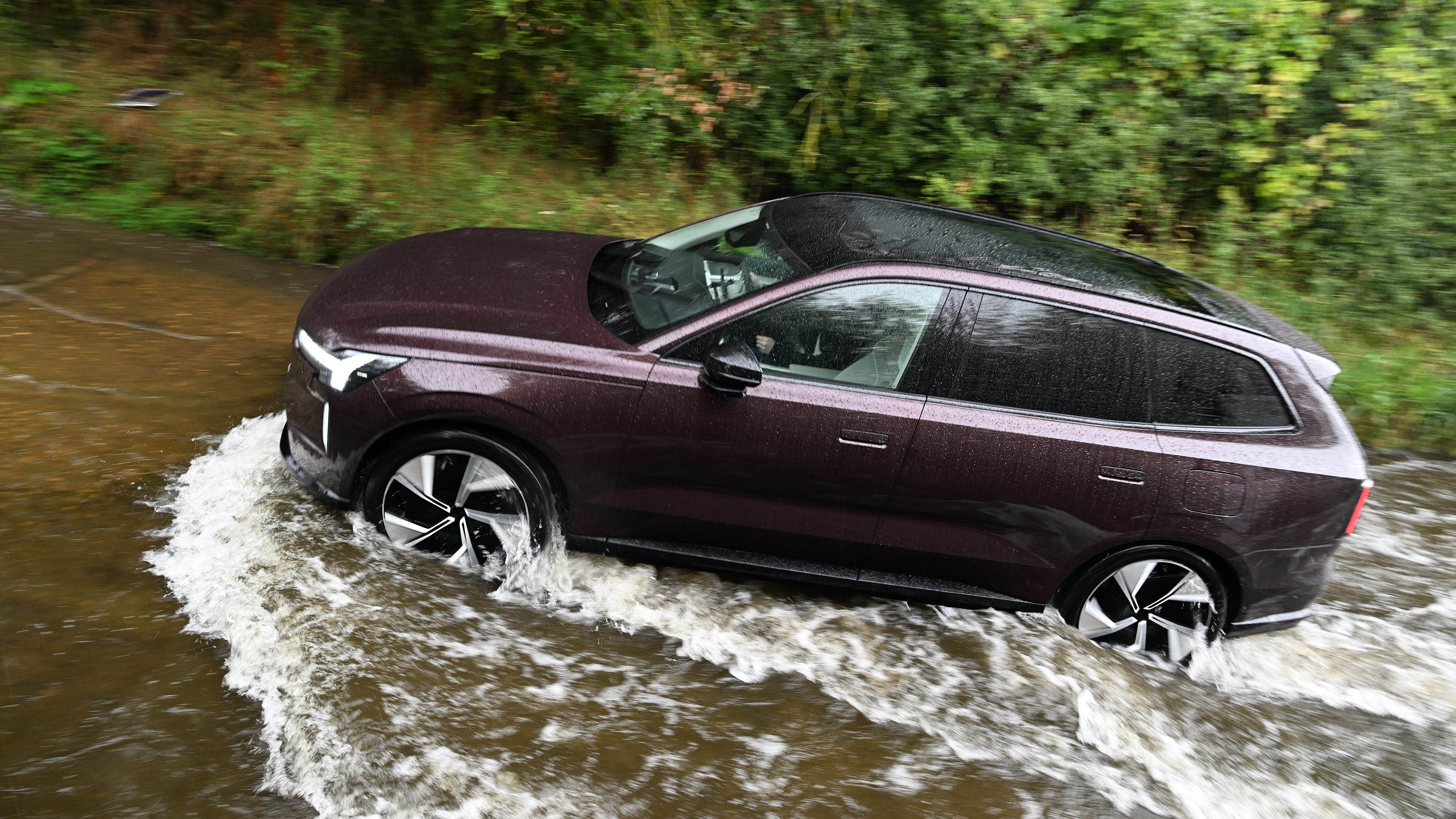 Volvo EX90 driving through deep water