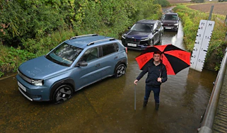 Auto Express consumer reporter Tom Jervis standing next to a selection of cars in a ford