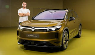 New Volkswagen ID. Tiguan - front static with Auto Express senior news reporter Alastair Crooks stood next to the car