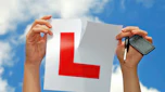 Person ripping up an L-plate