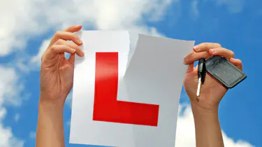 Person ripping up an L-plate