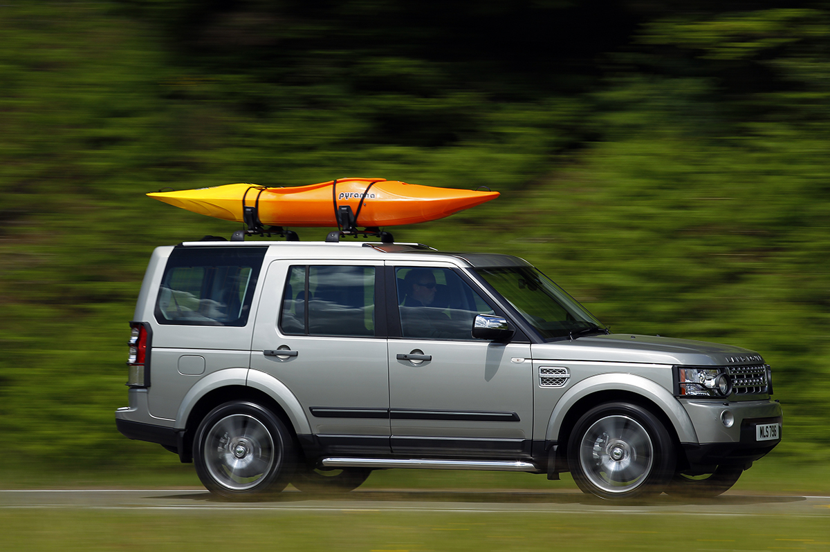 Land Rover Discovery with a boat on the roof
