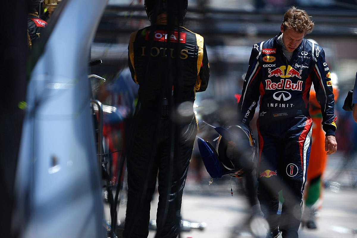 Sebastian Vettel walks back to the pits