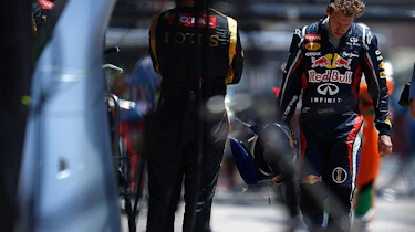 Sebastian Vettel walks back to the pits