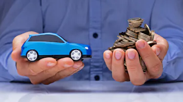Hands holding a toy car and coins