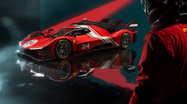 Racing driver looking at the Ferrari 499P Modificata