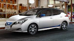 White Nissan Leaf parked outside a restaurant